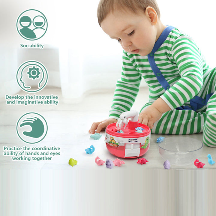 Child playing with a Mini Dinosaur Claw Machine, a fun and interactive kids' gift.