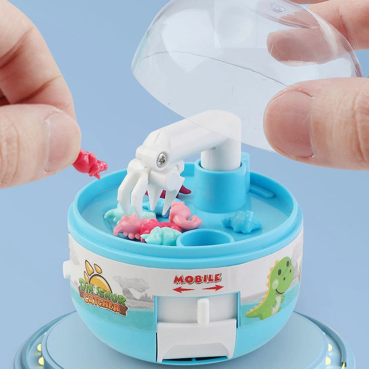 Assortment of colorful toy dinosaurs inside the Mini Claw Machine for kids' playtime.
