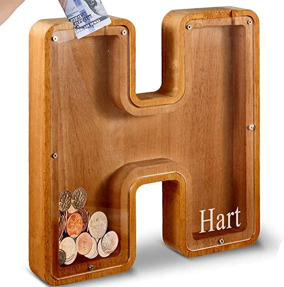 Brightly lit image of the Wooden Alphabet Piggy Bank, emphasizing its natural wood grain