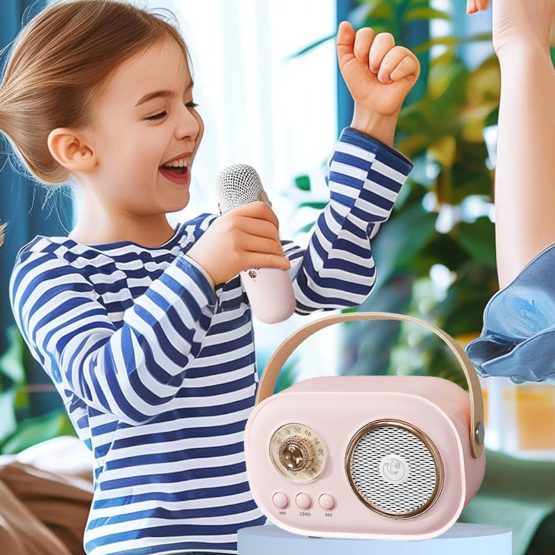 Happy child singing into a wireless microphone connected to a portable blue karaoke speaker.