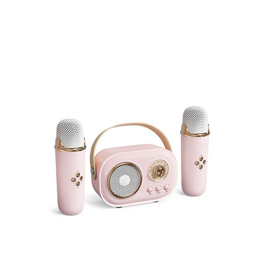 Back view of kids' karaoke speaker showing connectivity ports (USB, AUX) and power button, with mic.