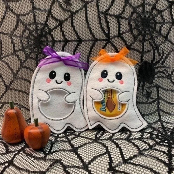 Halloween-themed party favors including ghost and pumpkin treat bags for children to collect candy