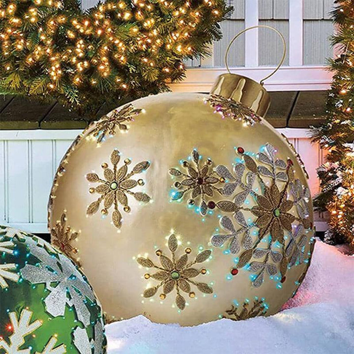Red inflatable Christmas ball with a green bow design, perfect for outdoor holiday decoration