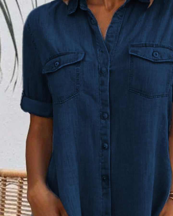 Woman wearing a light blue lightweight denim-look shirt dress, showcasing its casual versatile style.