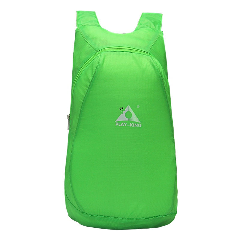 Hiker carrying a lightweight 20L foldable backpack, water-resistant for trails, outdoor gear, and day trips.