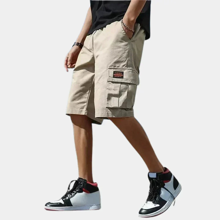 Lightweight men's cargo shorts for summer adventures, featuring a relaxed fit & practical pockets.
