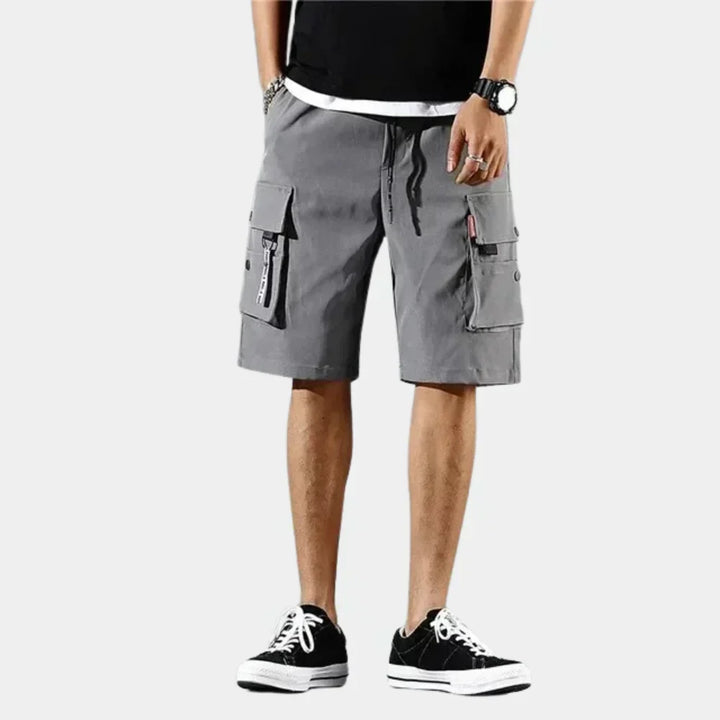 Practical men's travel cargo shorts, made from breathable cotton for warm weather and relaxed fit comfort.