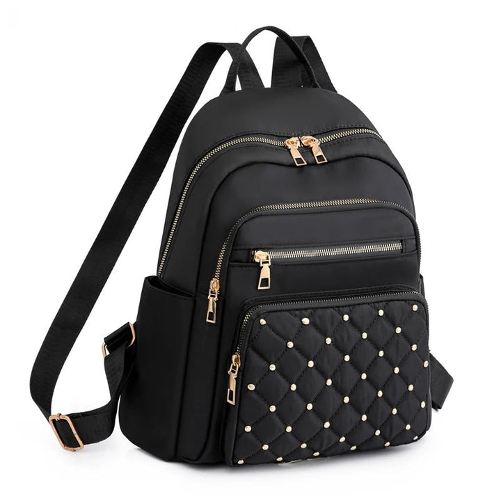 Lightweight water-resistant nylon backpack for women, ideal for travel, school, and daily commute.