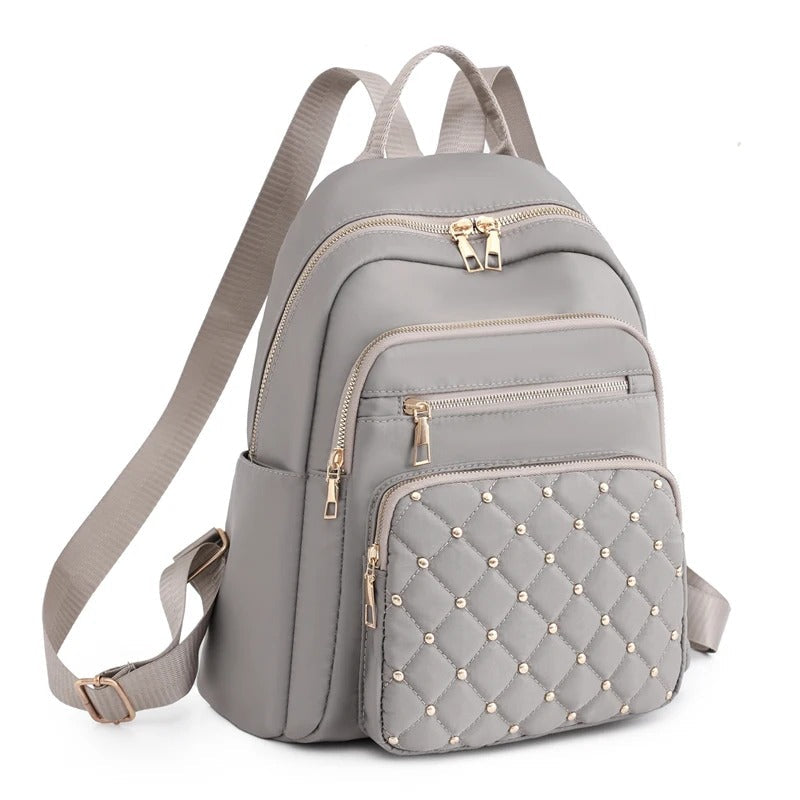 Stylish women's water-resistant nylon backpack, perfect for school, travel, and protecting your essentials.