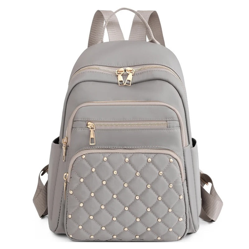 Versatile women's travel & school backpack, crafted from lightweight water-resistant nylon for daily use.