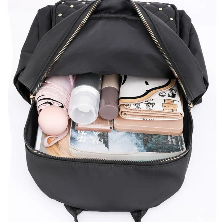 Durable water-resistant nylon backpack for women, perfect for school, travel, and any weather conditions.