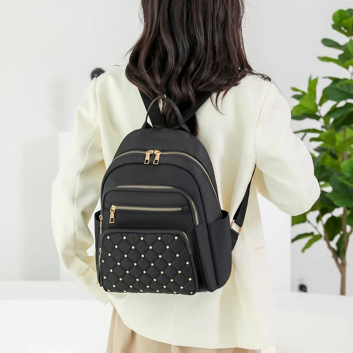 Women's school backpack, lightweight water-resistant nylon, ideal for books, laptops, and daily essentials.