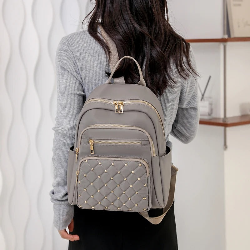Modern lightweight water-resistant nylon backpack for women, great for school, travel, & daily errands.