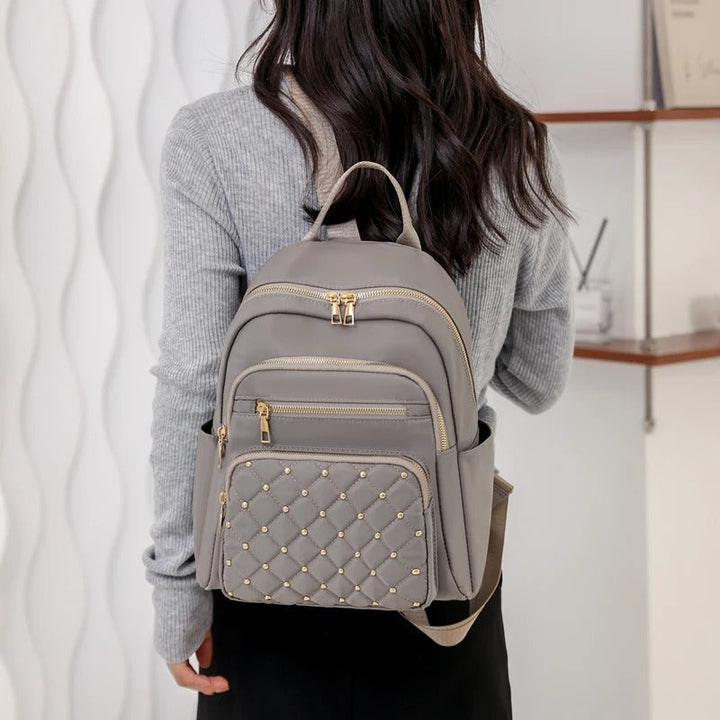Modern lightweight water-resistant nylon backpack for women, great for school, travel, & daily errands.