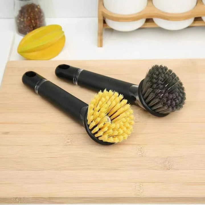Innovative utensil cleaning brush with an integrated soap dispenser, simplifying kitchen chores.