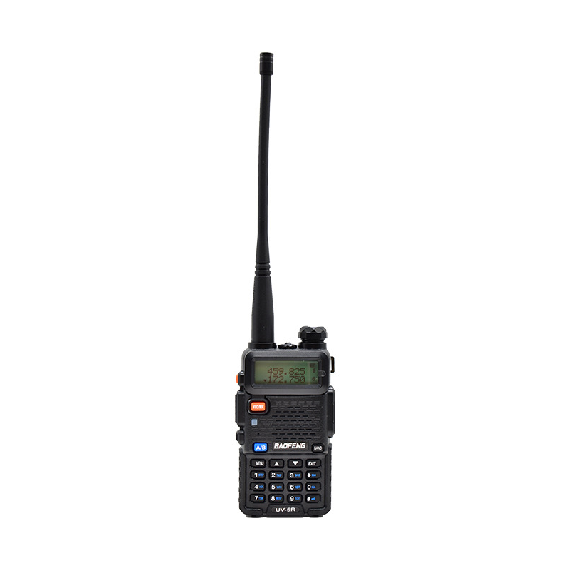 User operating a portable radio in a natural setting, showcasing real-world use for hiking