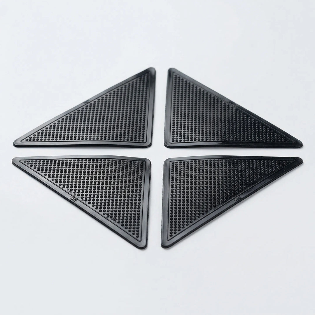 Reusable low profile rug gripper pads for corners, preventing slips and protecting floors & carpets.