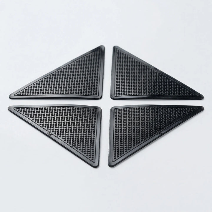 Reusable low profile rug gripper pads for corners, preventing slips and protecting floors & carpets.