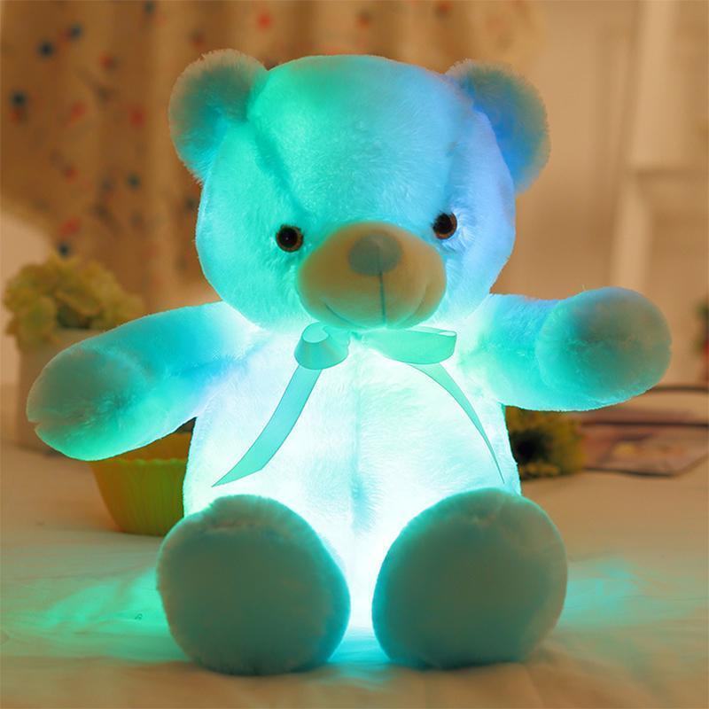 Close-up of a glowing LED plush bear's face, showing its soft texture and bright lights