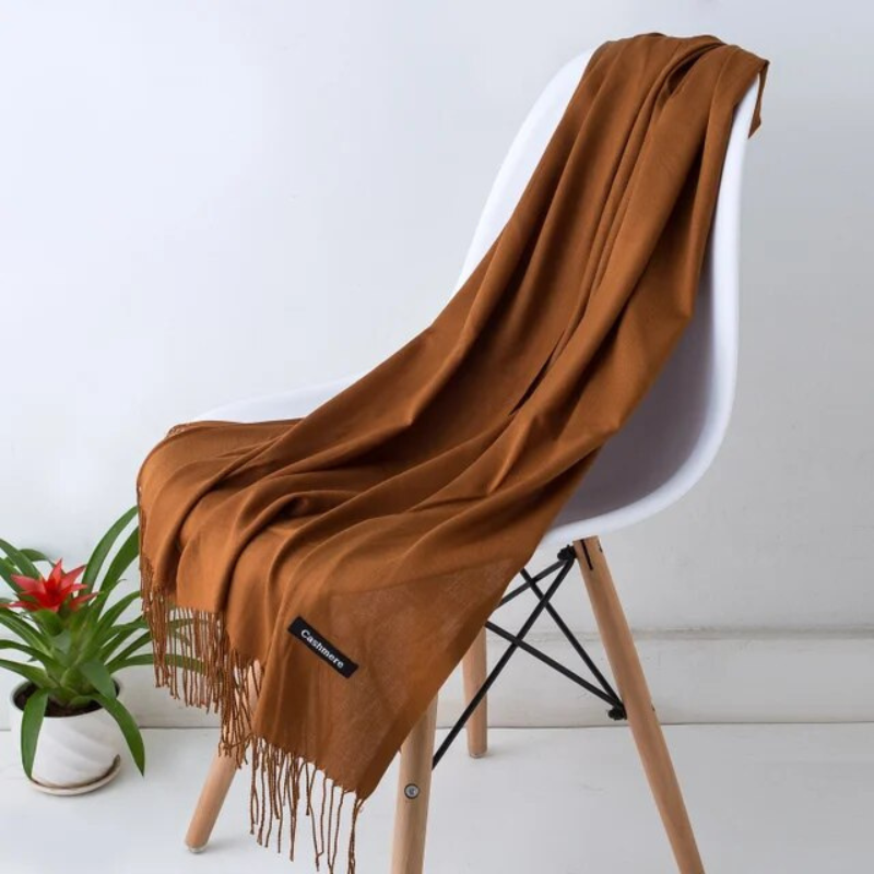 Stylish women's long cashmere blend scarf, offering luxurious softness for fall and winter style.