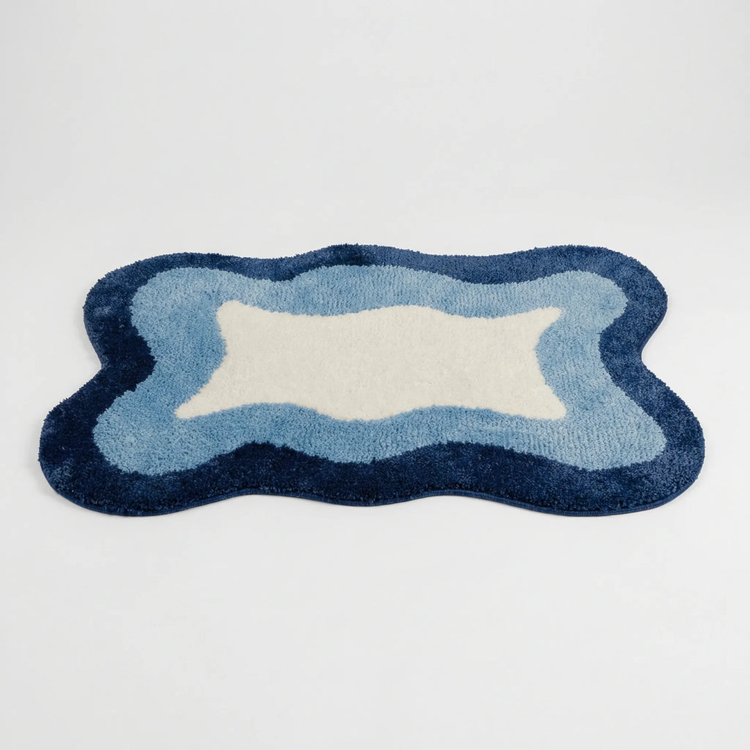 Non-slip Flowique wave pattern bath rug, perfect as an absorbent floor mat for bathroom, bedroom, or entryway.