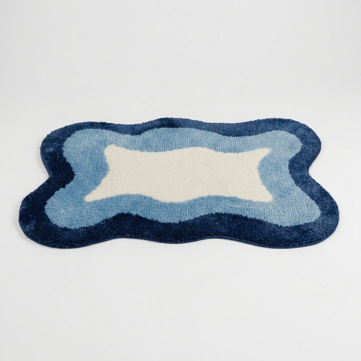 Non-slip Flowique wave pattern bath rug, perfect as an absorbent floor mat for bathroom, bedroom, or entryway.