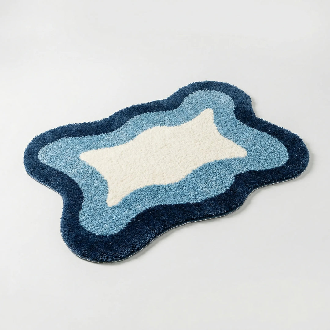 Close-up of a soft, unisex luxury bath rug. Features a distinctive Flowique wave pattern & non-slip backing for comfort.