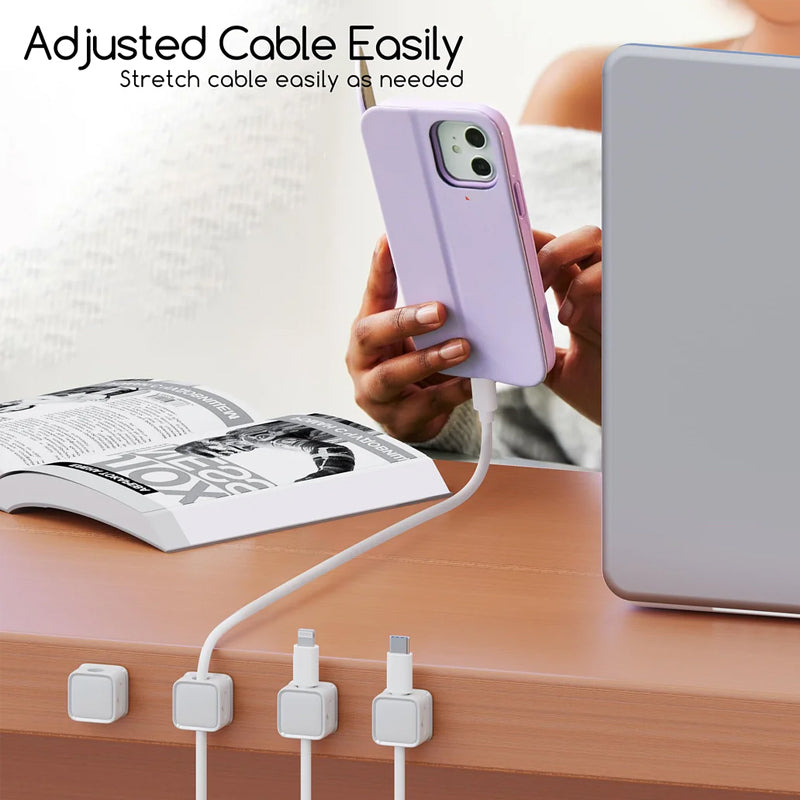Close-up of a black magnetic cable clip, perfect for organizing charging cords on a desk