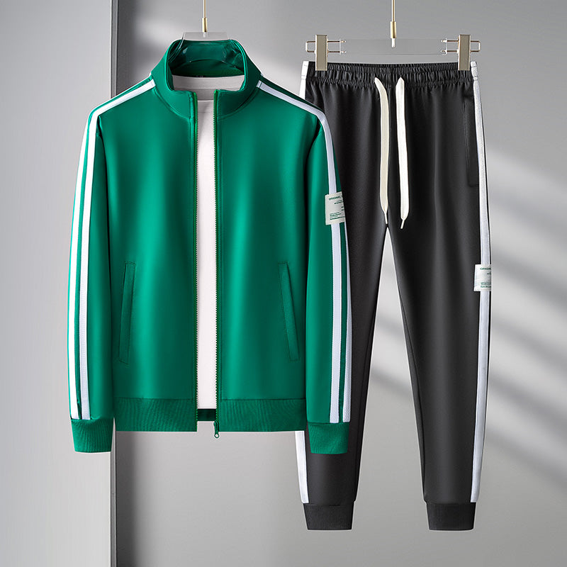 Close-up of men's athletic tracksuit jacket, black with white sleeve stripe, and joggers