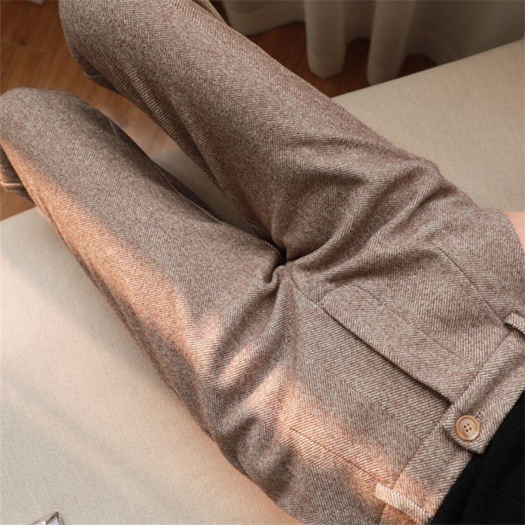 Rear view of men's grey tailored ankle-length pants, highlighting pocket detail and contemporary style.
