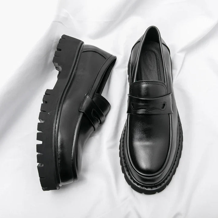 Men's black chunky sole loafers. Modern slip-on dress shoes for a sharp and versatile look.