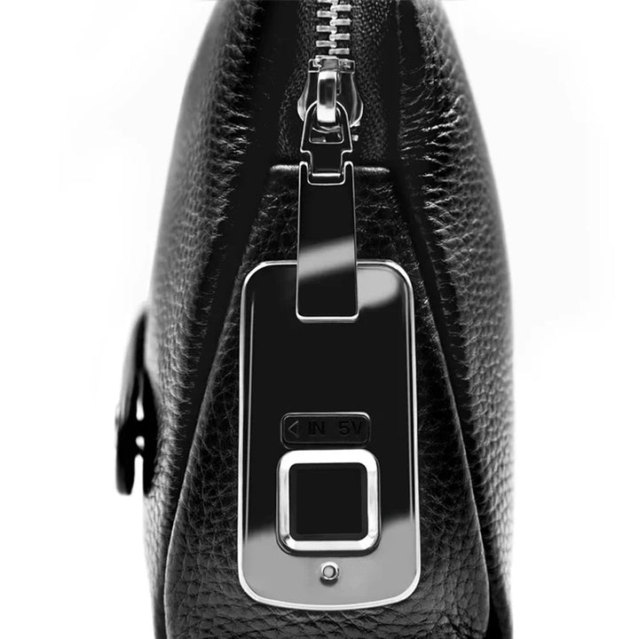 Close-up of the fingerprint sensor on a sleek men's leather anti-theft clutch bag.