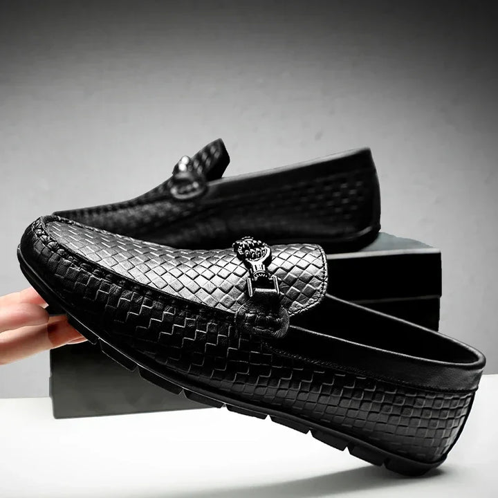 Detailed shot of the stitching on a black leather men's grip loafer, quality craftsmanship