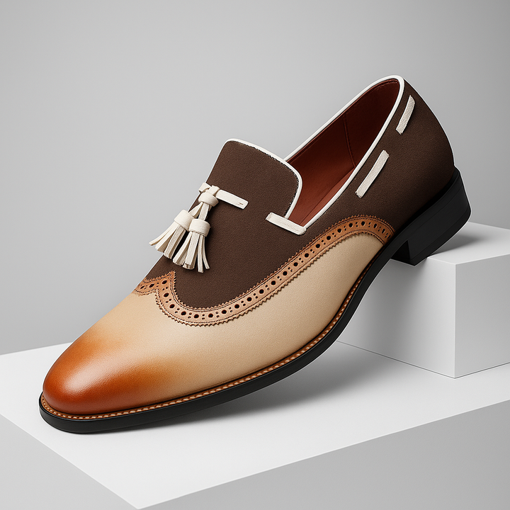 Men's black leather tassel loafers with intricate brogue detailing and cushioned sole, side view.