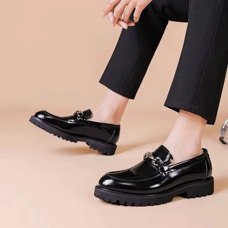Men's polished brown leather loafers, versatile for office and formal occasions.