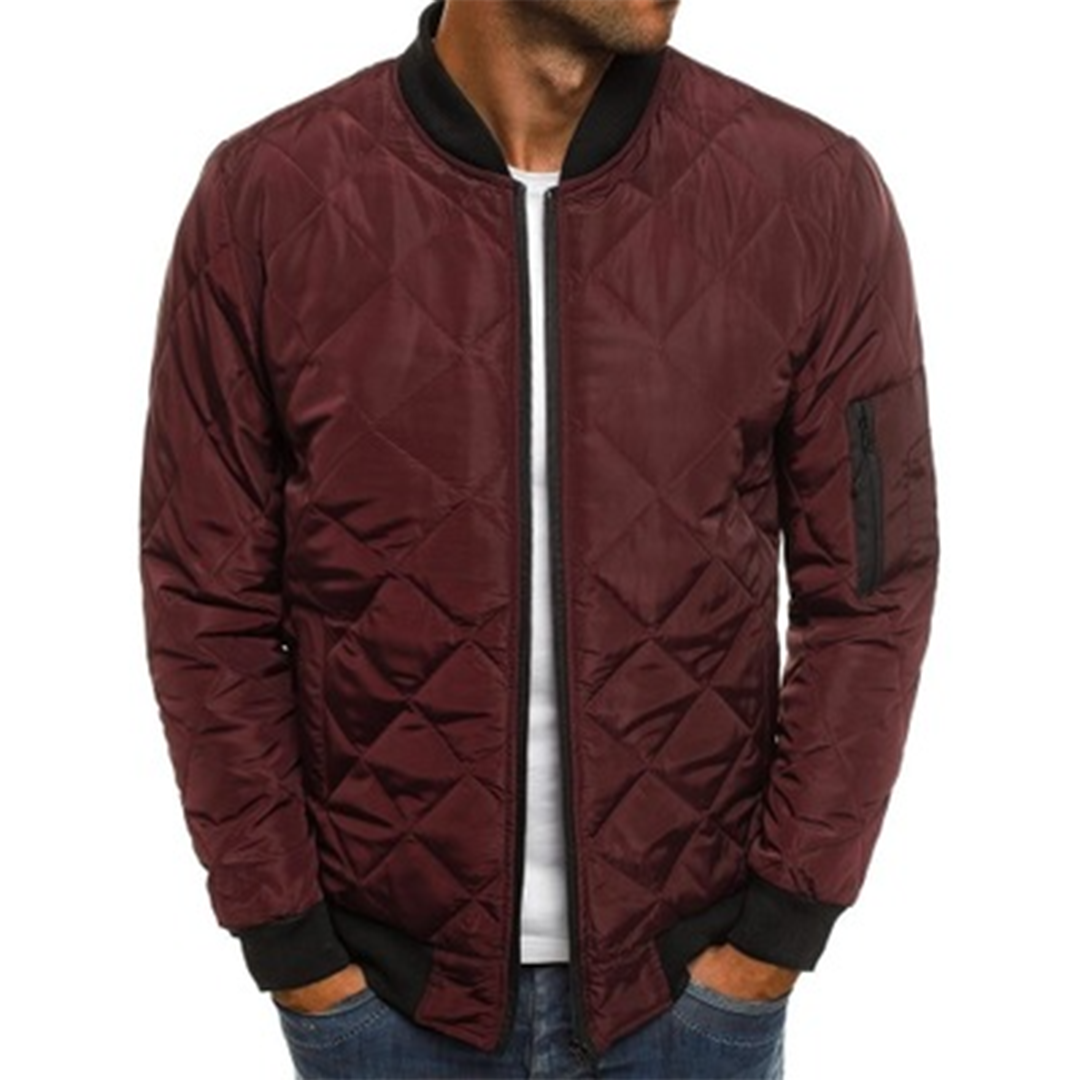 Casual men's quilted jacket in a dark color, showcasing modern streetwear fashion.
