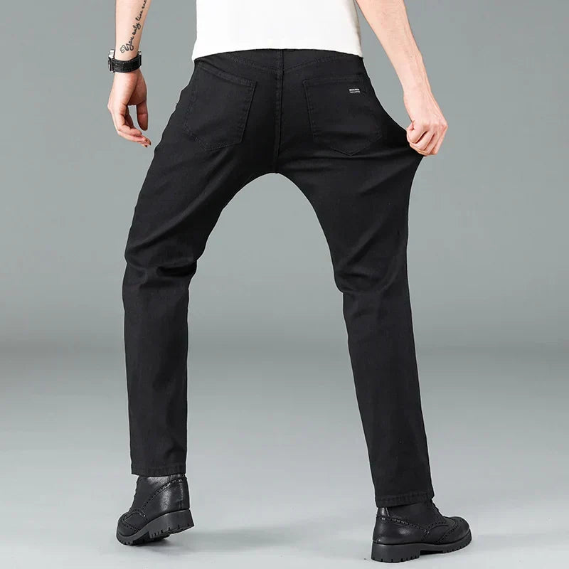 Modern men's straight fit black stretch jeans. A key piece of men's fashion, offering a sleek look and comfort.