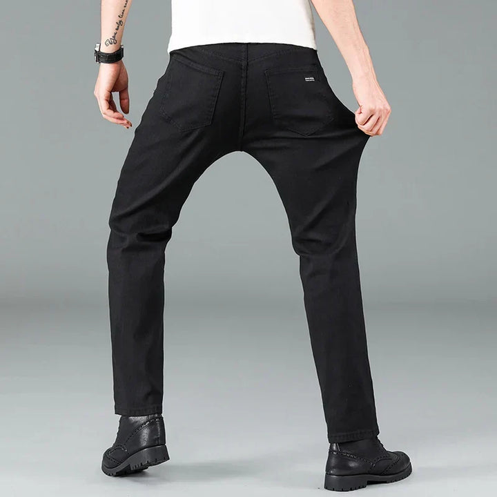 Modern men's straight fit black stretch jeans. A key piece of men's fashion, offering a sleek look and comfort.