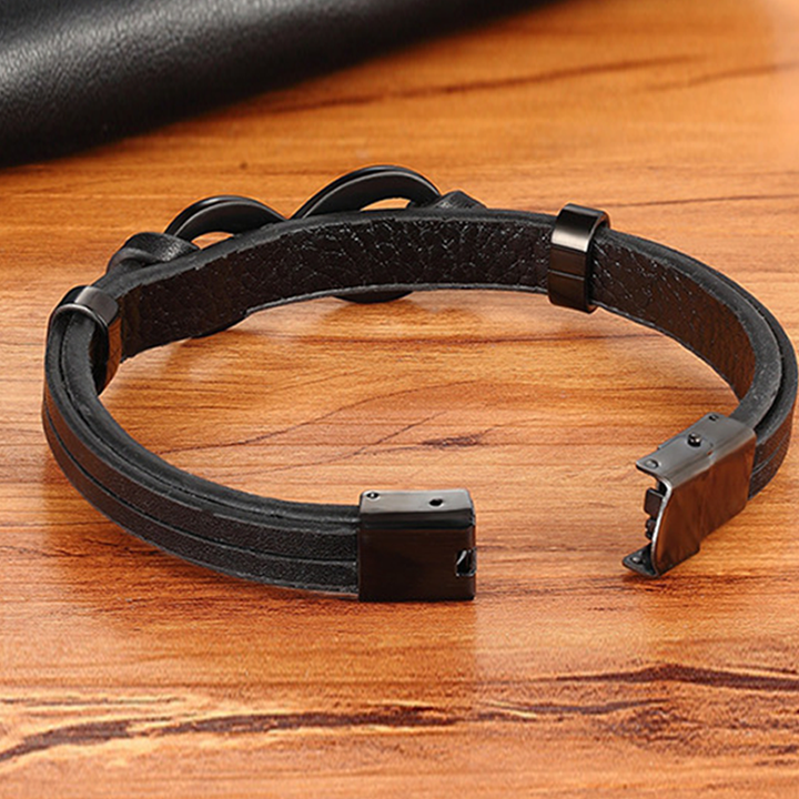 Close-up of a men's braided leather bracelet, showcasing the intricate weave and polished stainless steel.
