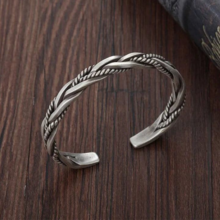 Handcrafted men's braided sterling silver cuff bracelet, an elegant and adjustable piece of silver jewelry.