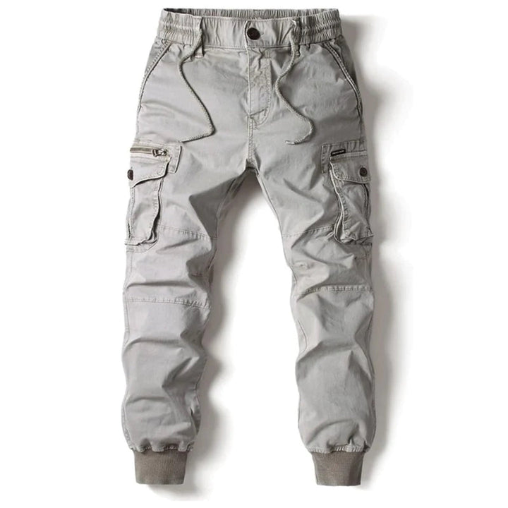 Stack of men's jogger pants in different colors, all featuring an elastic waist and comfortable design.