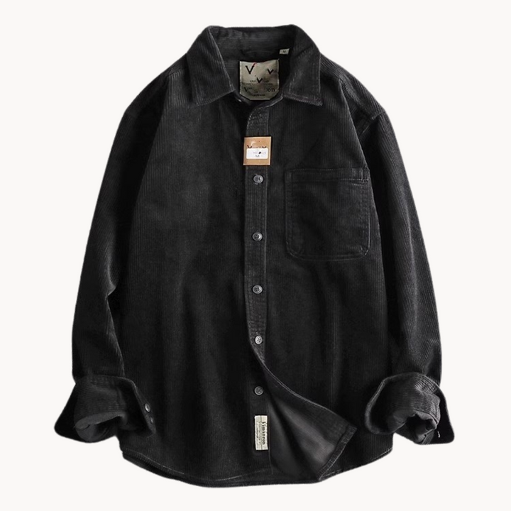 Stack of folded men's casual corduroy shirts in various colors, showcasing fabric texture