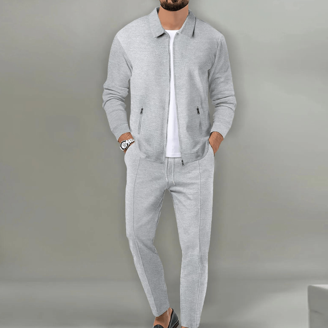 Men's fashion tracksuit in dark blue, including a zippered top and jogger bottoms for comfort.