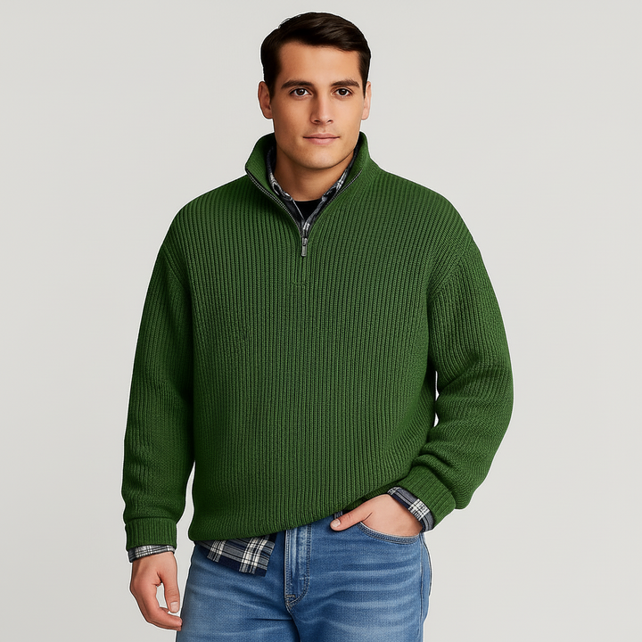Stylish man wearing a blue half-zip pullover sweater, showcasing casual men's fashion and comfort.