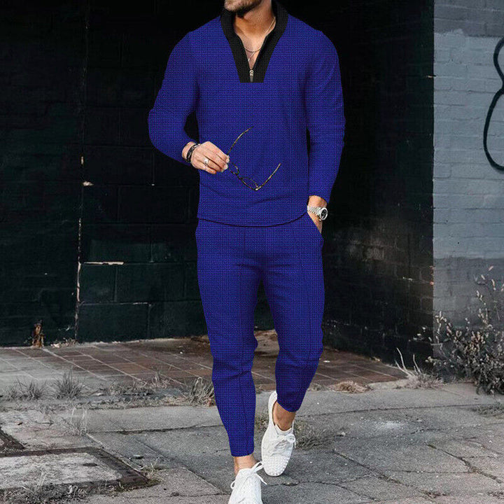 Blue men's casual two-piece outfit with a trendy zip-top and relaxed trousers, perfect for modern casual wear.