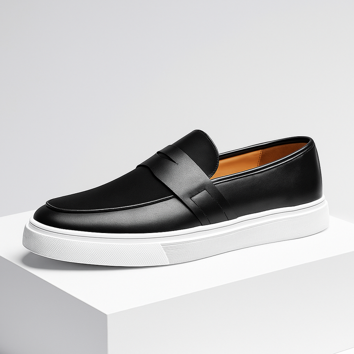 Close-up of the textured leather on men's casual slip-on loafers in a dark hue