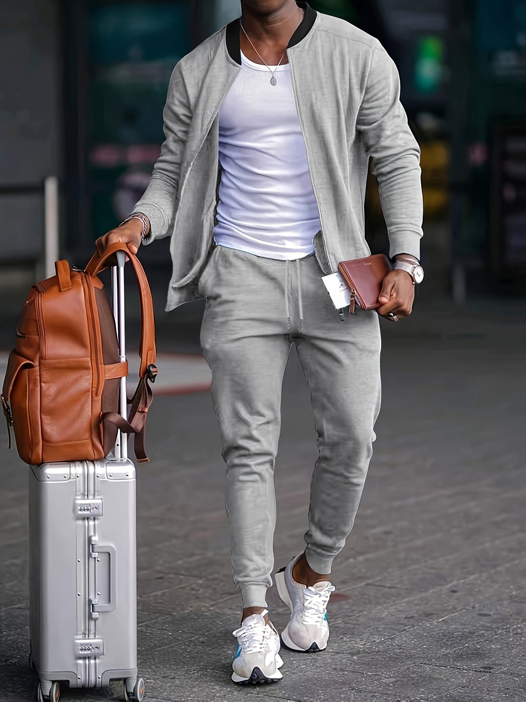 Stylish men's loungewear: navy blue zipper jacket and joggers, ideal as a comfortable travel outfit.