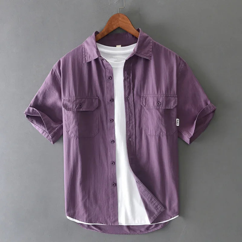 Green men's short sleeve casual workwear style shirt with a button-up front, offering a relaxed summer fit.
