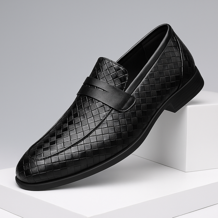 Close-up of dark brown woven leather texture on men's penny loafers, formal dress shoe