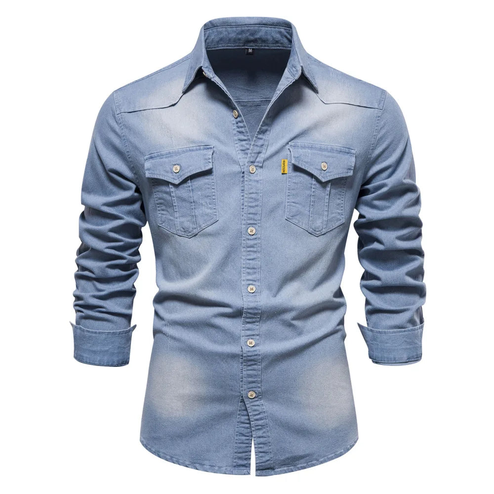 Close-up of fabric on a men's blue denim long sleeve button-up shirt, texture visible